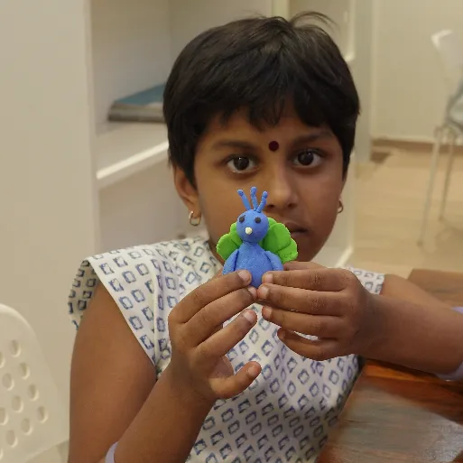 Child sculpting clay masterpiece